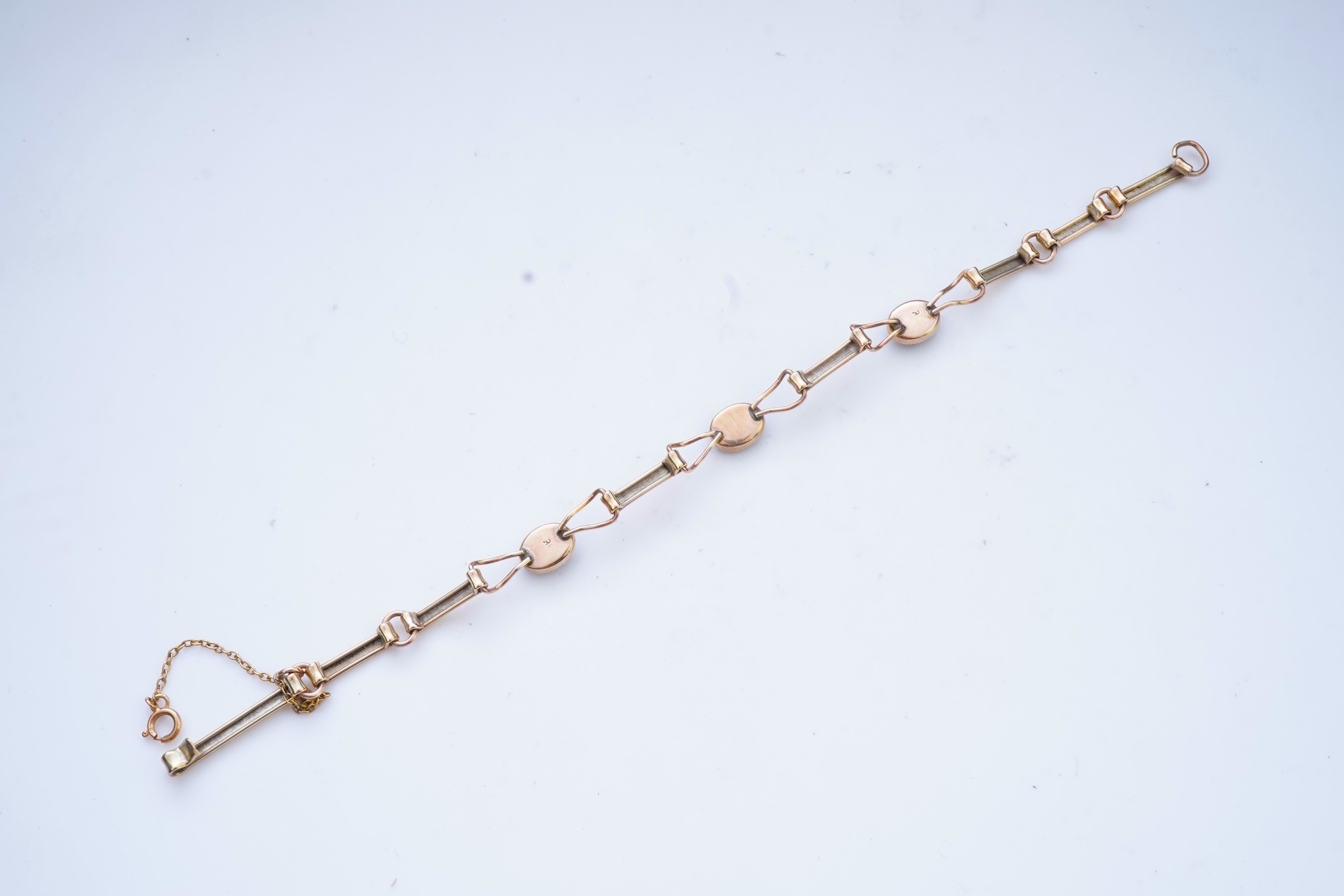An opal triplet bracelet and pair of earrings, comprising: a gold bracelet set with opal triplets, length 18cm; and a pair of studs set with opal doublets, mounted in gold, length 0.8cm each, post fittings, stamped 585,